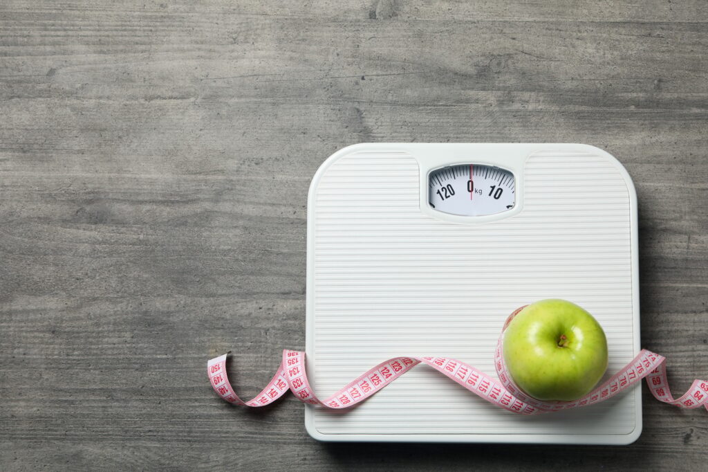 Diet and weight loss, healthy lifestyle, composition with measuring tape, space for text